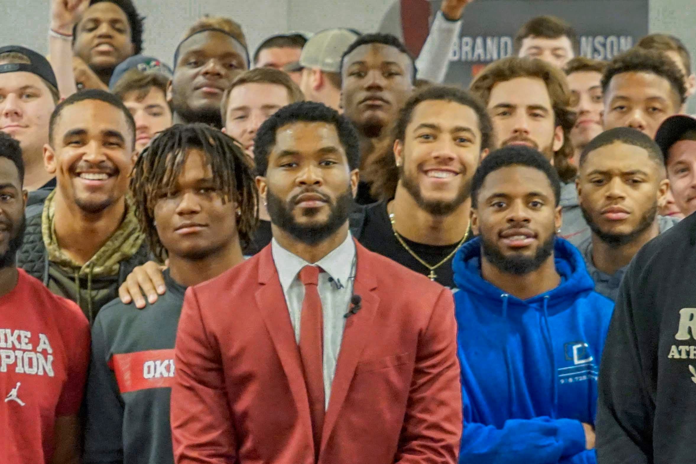 Brandon Johnson speaking to a team of athletes