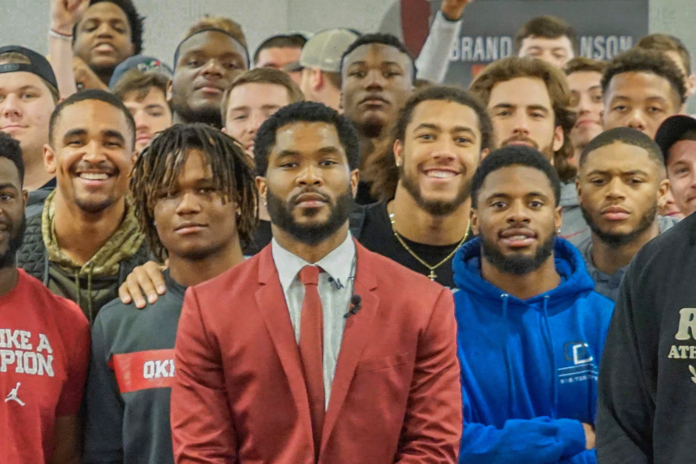 Brandon Johnson speaking to a team of athletes